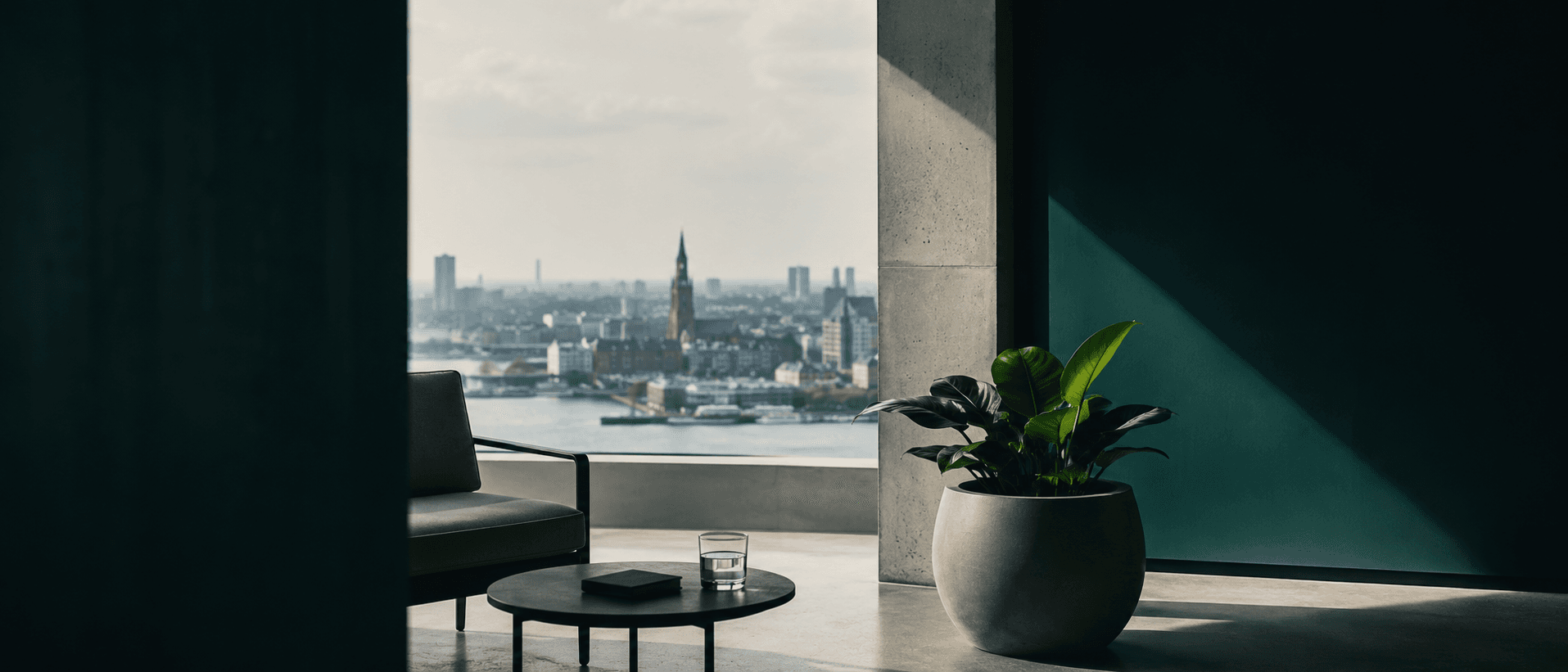 A quiet high-floor lounge with a view over Antwerp and the Scheldt